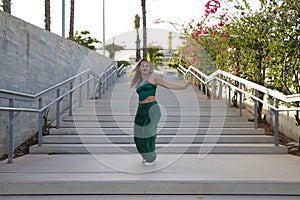 Latin and Hispanic girl, young and beautiful, dancing modern dance in the street outdoors. Dance concept, moonwalk, jumpstyle,