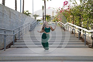 Latin and Hispanic girl, young and beautiful, dancing modern dance in the street outdoors. Dance concept, moonwalk, jumpstyle,