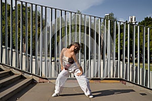 Latin and Hispanic girl, young and beautiful, dancing modern dance in the street outdoors. Dance concept, moonwalk, jumpstyle,