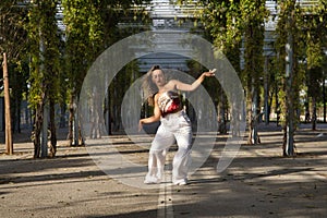 Latin and Hispanic girl, young and beautiful, dancing modern dance in the street outdoors. Dance concept, moonwalk, jumpstyle,
