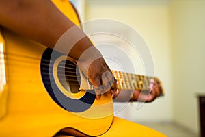 latin hispanic woman learning to play on guitar