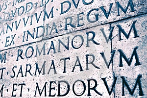 Latin inscription on the outside wall of Ara Pacis wall in Rome, Italy