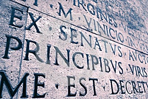 Latin inscription on the outside wall of Ara Pacis wall in Rome, Italy