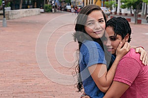 Latin Lesbian couple embracing in the city