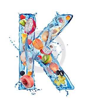 Latin letter K made of water splashes with different fruits and berries