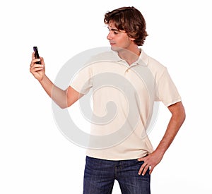 Latin man in jeans reading on cellphone