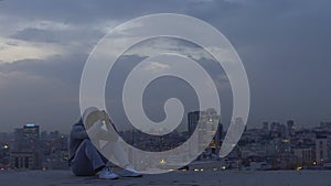 Latin man meditating on roof of skyscraper trying to make important decision