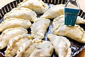 Latin man`s hand preparing typical Argentine and South American pastries,