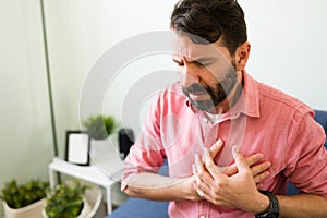 Latin man with suffering from a heart failure photo