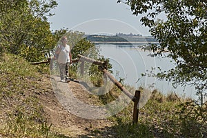 Latin mature woman walking on a tourist trail, Palmar National Park, Argentina