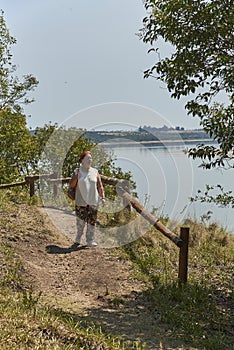 Latin mature woman walking on a tourist trail, Palmar National Park, Argentina