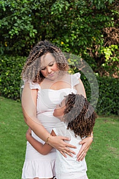 Latin mother and daughter spend time together outdoors