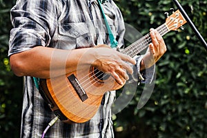 Latin musician playing a guitar at the street in Mexico city