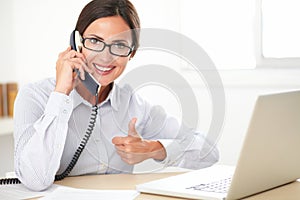 Latin receptionist talking on the phone