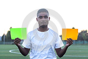 latin soccer player showing two colored banners. Soccer match concept