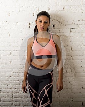 Latin sport woman posing in fierce and badass face expression with fit slim body