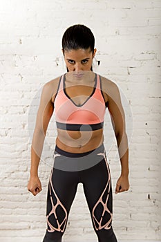 Latin sport woman posing in fierce and badass face expression with fit slim body