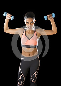 Latin sport woman posing in fierce expression holding dumbbell hand weigh