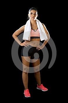 latin sport woman posing with towel in fierce and badass face expression