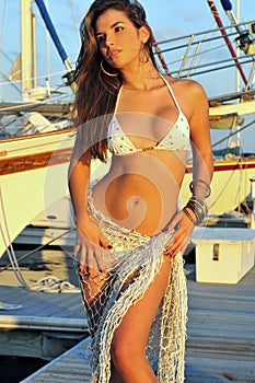 Latin swimsuit fashion model posing at boat marina