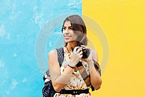 Latin Tourist Woman traveling in Mexico with map and camera on hand. Mexican Girl on backpacking vacation