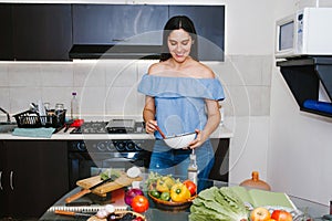 Latin woman cooking healthy food in a mexican kitchen in Mexico city
