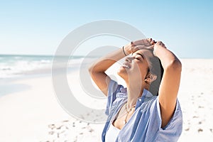 Latin woman enjoy the sun while relaxing at beach
