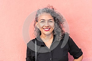 Latin woman with gray hair standing in the street