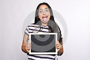 Latin woman holding chalkboard.