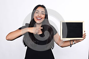 Latin woman holding chalkboard.