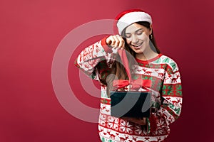 Latin woman opening Christmas gift