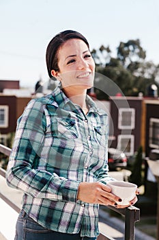 Latin woman portrait drinking coffee in a terrace in mexican house in Mexico city