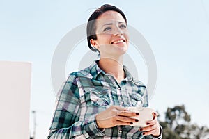 Latin woman portrait drinking coffee in a terrace in mexican house in Mexico city