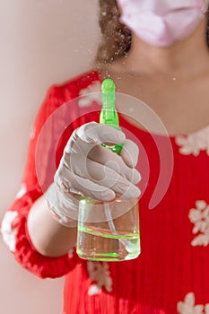 Latin woman with red dress woman taking precautions by covid-19 wear a face mask, gloves and sprayer to prevent infection coronavi photo