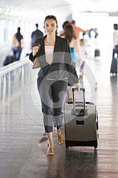 Latin woman running at the airport