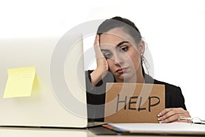 Latin woman showing help sign desperate suffering stress at work while sitting at office laptop