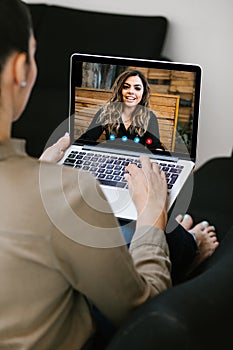 Latin woman talking to her mexican colleagues in video conference business team using laptop for a online video call