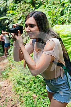 Latin Woman Using Camera In Tropical Forest