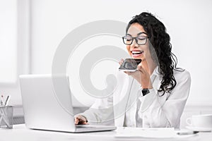 Latin woman using smart phone voice recognition function