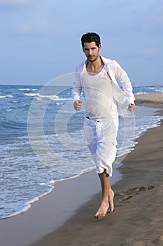 Latin young man white shirt walking blue beach
