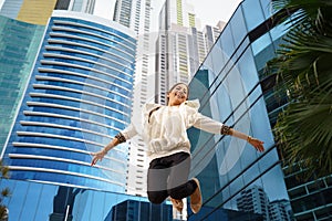 Latina business woman jumping joy happy office smile