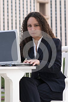 Latina Business Woman at Laptop Computer