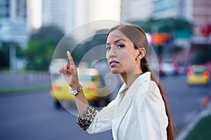 Latina businesswoman calling taxi car leaving work