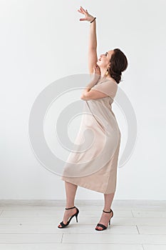 Latina dance, strip dance, contemporary and bachata lady concept - Woman dancing improvisation on a white background