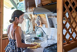Latina Woman Cleaning the Countertop in a Rustic Countryside Kitchen