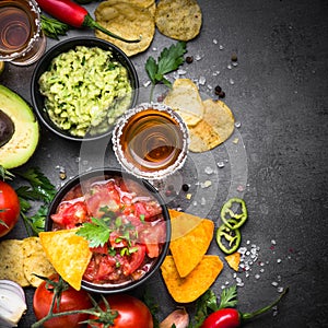 Latinamerican food party sauce guacamole, salsa, chips and tequi