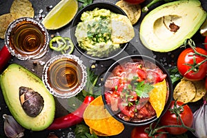 Latinamerican food party sauce guacamole, salsa, chips and tequi photo
