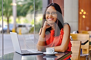 Latinamerican girl have a coffee break in a cafe