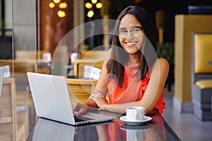 Latinamerican girl have a coffee break in a cafe photo