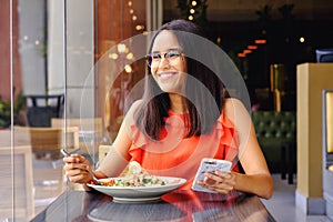 Latinamerican girl have a lunch in restaurant